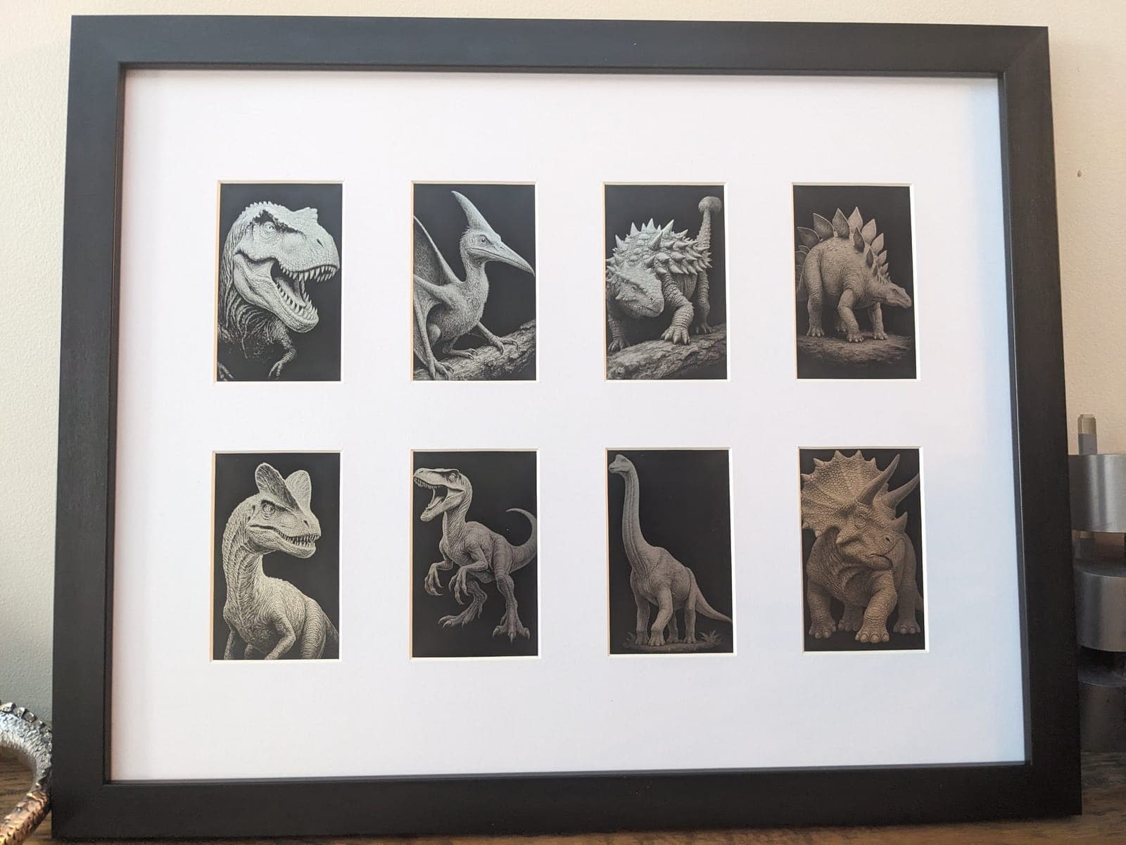 Eight small dinosaur engravings in one frame