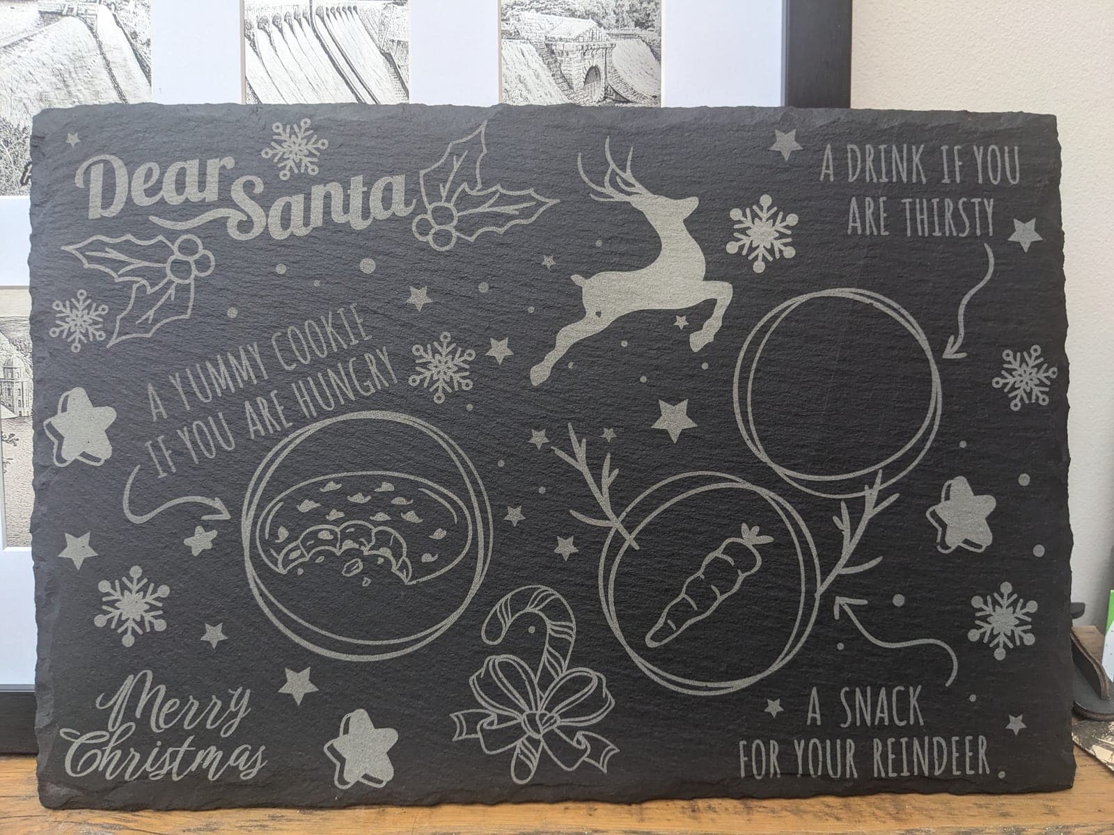A slate Christmas Eve board with spaces for a cookie, a drink and a carrot for the reindeer